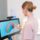 Dentist reviewing a 3D digital scan of teeth on a touchscreen monitor in a modern dental clinic