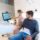 Dentist showing digital smile design to patient in modern clinic