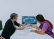 Dentist reviewing dental X-ray with senior patient during consultation