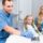 Parents supporting their child during a dental clinic visit.