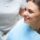 Young woman looking in a mirror during dental treatment.