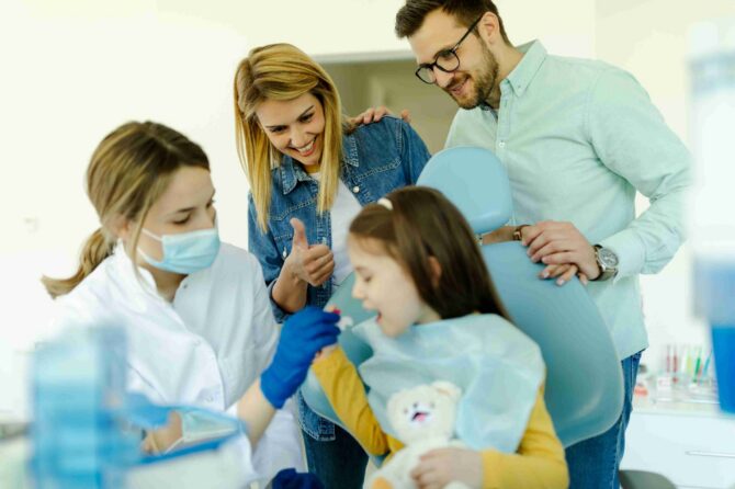 Family dental visit with a child and parents in a clinic.