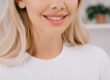 Close-up of a woman with a bright white smile.