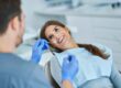 Dentist examining a smiling patient during a dental checkup.