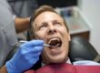 Dentist examining a patient's teeth during a dental checkup.